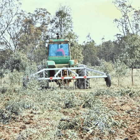 Image (18 Yeomans plow on a green tractor with Obstructions trees and roots